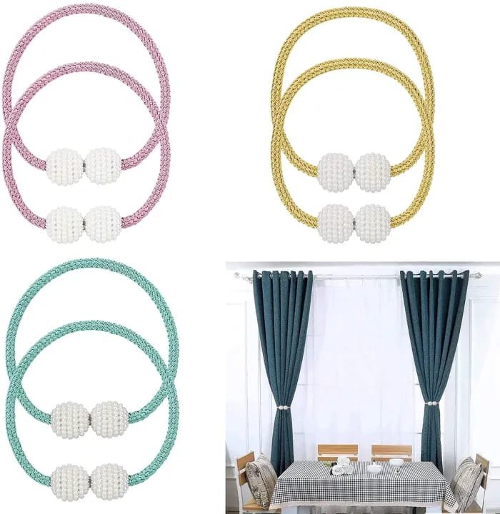Set of curtain tiebacks with decorative balls in pink, gold, and teal, shown with a dining room setting.